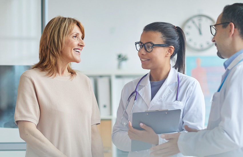 Happy patient talking to doctors